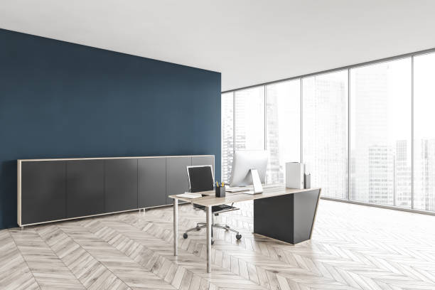 istock Grey and blue office room with chair, table and computer near window 1309731391