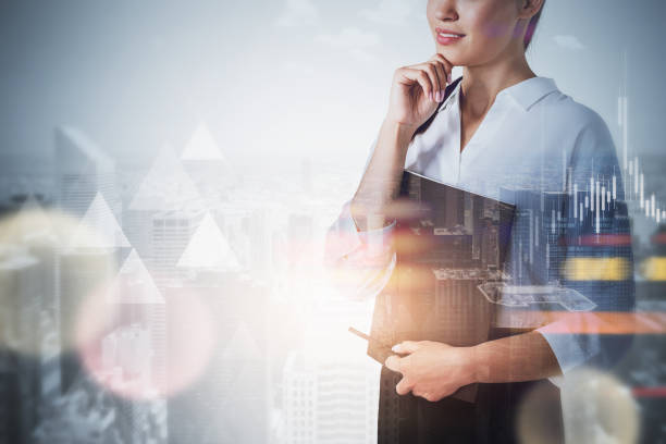 istock Thoughtful woman in city and graphs 1309732501