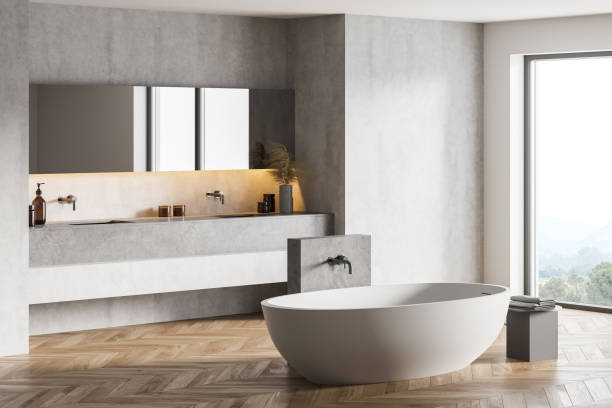 istock Bathtub and sinks with mirror in dark bathroom with window 1309732688