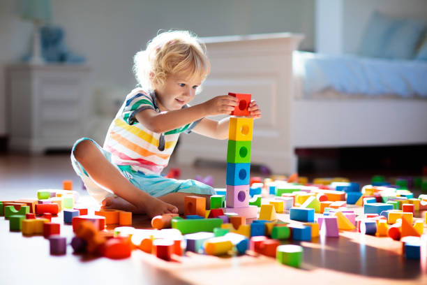 istock Child playing with colorful toy blocks. Kids play. 1309733154