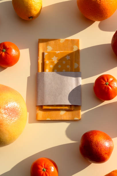 Reusable food beeswax wrappers in different sizes. Organic fabric covers for storing food. Zero waste concept. Reusable food beeswax wrappers in different sizes. Organic fabric covers for storing food. Zero waste concept. Creative still life. beeswax wrap stock pictures, royalty-free photos & images