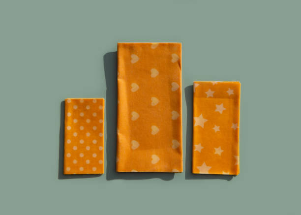 Reusable food beeswax wrappers in different sizes. Organic fabric covers for storing food. Zero waste concept. Reusable food beeswax wrappers in different sizes. Organic fabric covers for storing food. Zero waste concept. Creative still life. beeswax wrap stock pictures, royalty-free photos & images