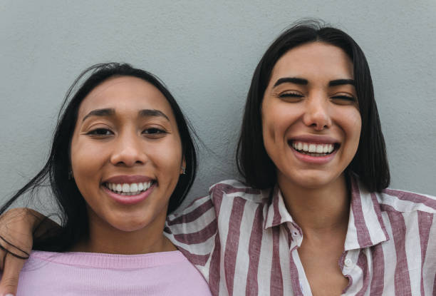 istock Happy Latin women having fun smiling together in front of camera 1309734591