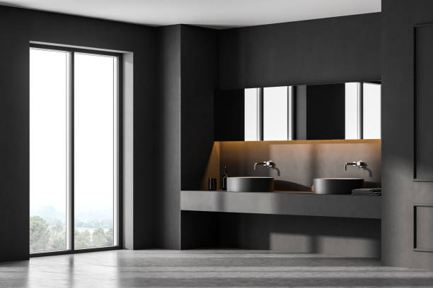 istock Grey bathroom with two sinks near window on marble floor 1309734978
