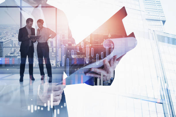 istock Man with clipboard, his colleagues and graphs 1309735008