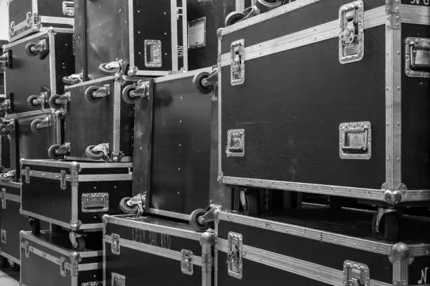 Photo of Protective flight cases on backstage zone. Storage with empty flight cases from professional concert equipment.