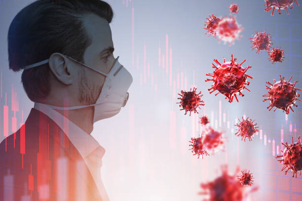 istock Man in protective mask, red coronavirus and graphs 1309735847