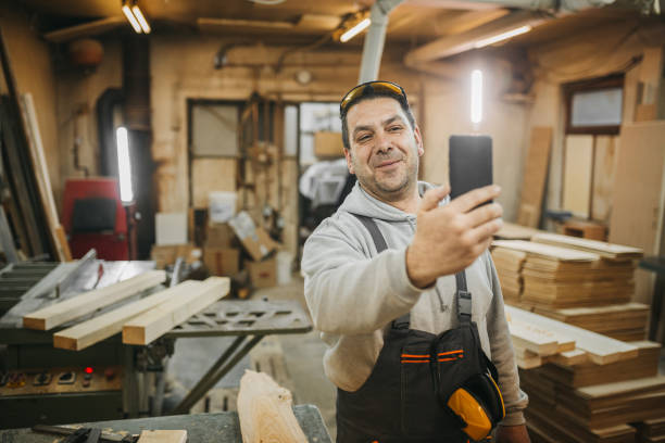 istock The carpenter uses the phone 1309736586