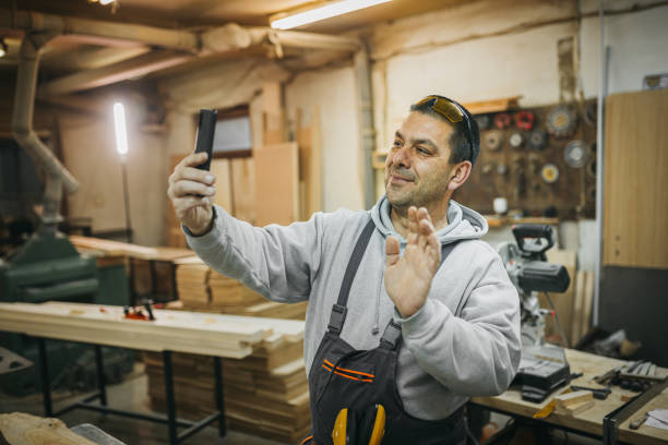 istock The carpenter uses the phone 1309737226