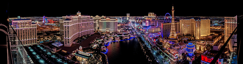 Las Vegas, Nevada/ USA - March 14, 2022: Aerial view of Las Vegas Strip at night.\n\nLas Vegas is the largest city in the US state of Nevada and a world-renowned center for gambling, shopping, fine dining and entertainment. It is mainly famous for its many casinos and the accompanying entertainment-tourism activities, which earned it the nickname of the Entertainment Capital of the World.