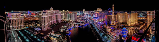 The famous Las Vegas Strip with the Bellagio Fountain. The Strip is home to the largest hotels and casinos in the world. Las Vegas, USA - February 17, 2019 Panoramic view of Las Vegas strip at night in Nevada. the strip las vegas stock pictures, royalty-free photos & images