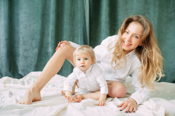istock Happy mother sits and plays with her little son. 1309738514