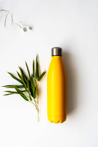istock A yellow reusable bottle and a bamboo branch 1309738660
