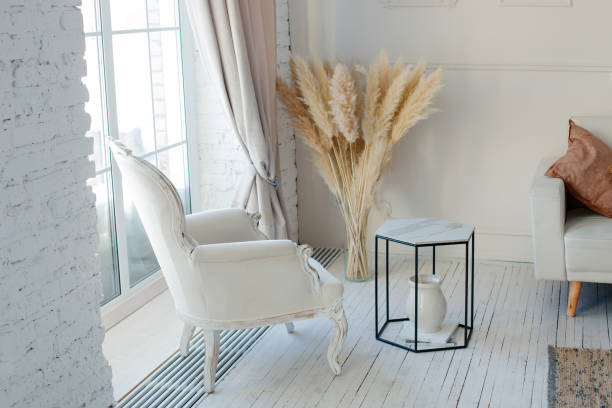 Stylish Scandinavian modern white cozy eco interior in minimalist style. Modern home decor with Pampas grass in vase. Open space. Monochrome, copy space Stylish Scandinavian modern white cozy eco interior in minimalist style. Modern home decor with Pampas grass in vase. Open space. Monochrome, copy space pampas photos stock pictures, royalty-free photos & images