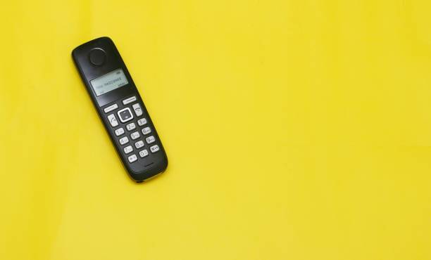 istock Cordless phone  on a yellow  background 1309744293