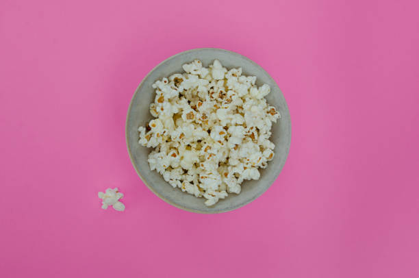 istock Bowl of popcorn and popcorn on background. 1309745427