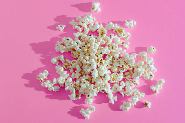 istock A pile of popcorn on pink background. 1309745555