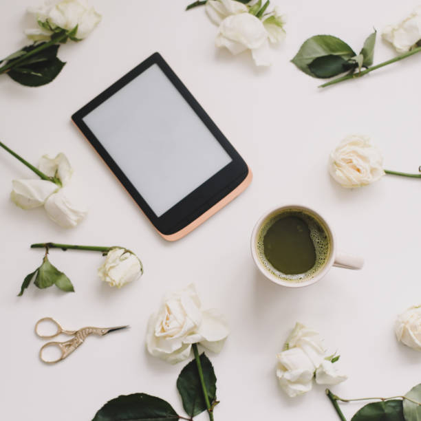 istock Floral composition with tablet, roses on white background. Flatlay, top view. Copy space mockup template. 1309746842