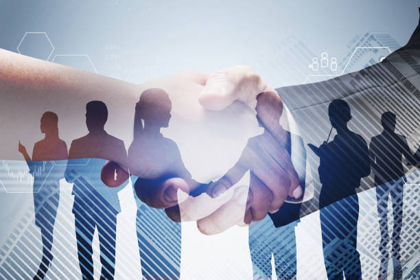 istock Man and woman shaking hands and team 1309746957