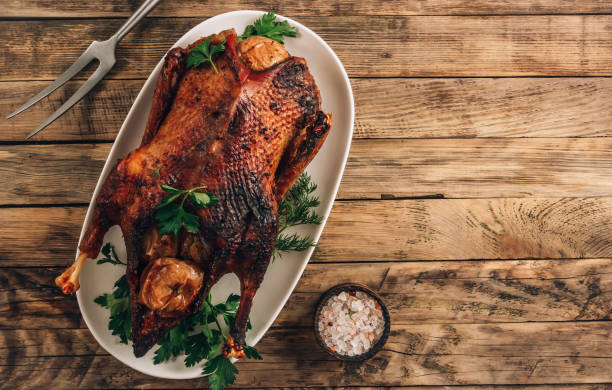 istock Whole crispy golden roast duck with marinated with fresh apples for a festive dinner. 1309747192