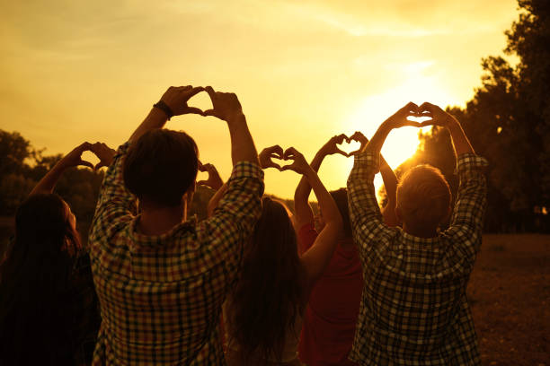 istock Hands in the shape of hearts on a sunset 1309747208