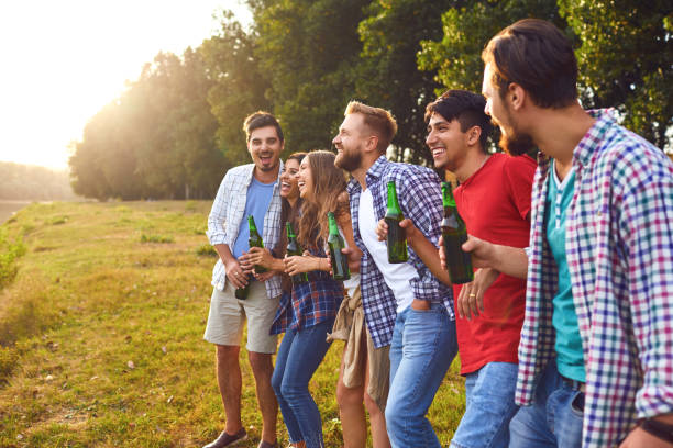 istock Young people drink and clink glasses at a picnic 1309747209
