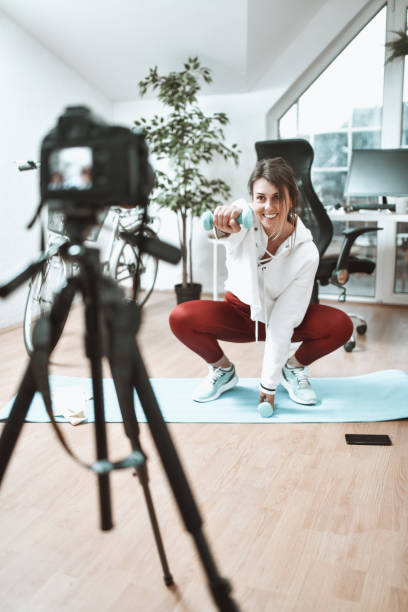 istock Home Exercising Vlog By Cute Smiling Female In Office 1309747725