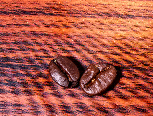 Roasted coffee beans on white background. on wooden background. Top view.