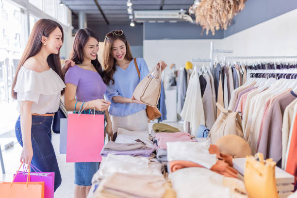 istock women shopping at clothes store 1309749608