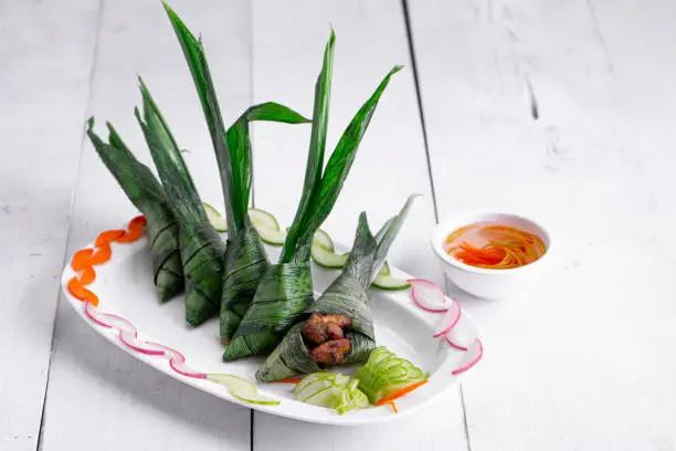 Photo of Palm leaf wrapped chicken