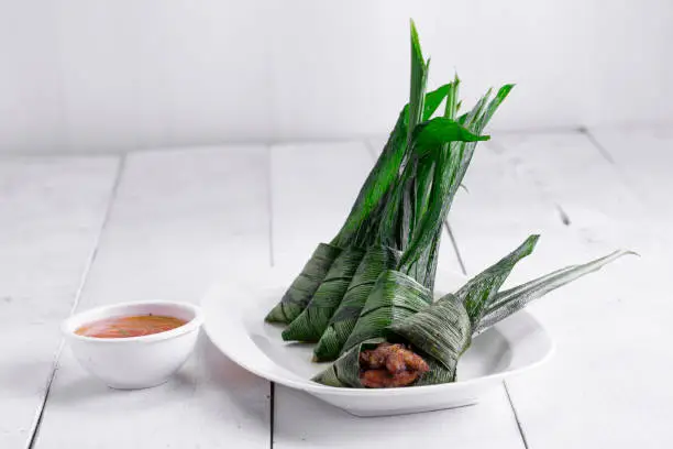 Photo of Palm leaf wrapped chicken