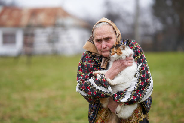 istock Old woman playing with her cat outdoor 1309755106