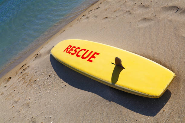 close up yellow surfing board on sand sea beach - surf rescue imagens e fotografias de stock