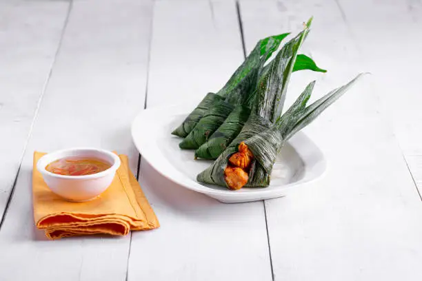 Photo of Palm leaf wrapped chicken