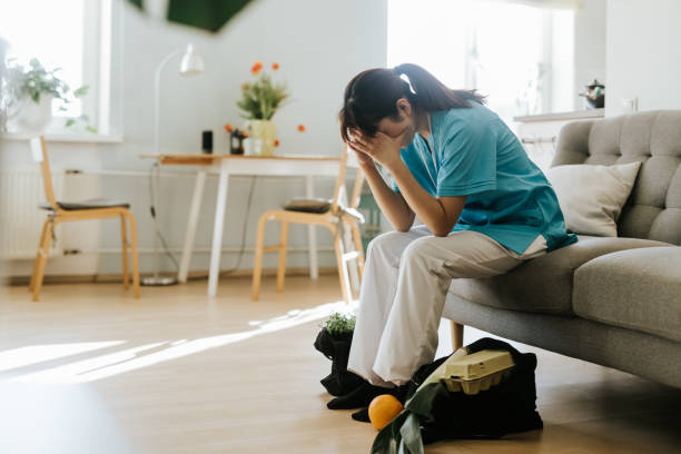 istock Overworked healthcare worker stressed at home 1309755904