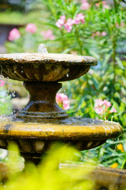 istock Garden fountain flowing with drop 1309756313