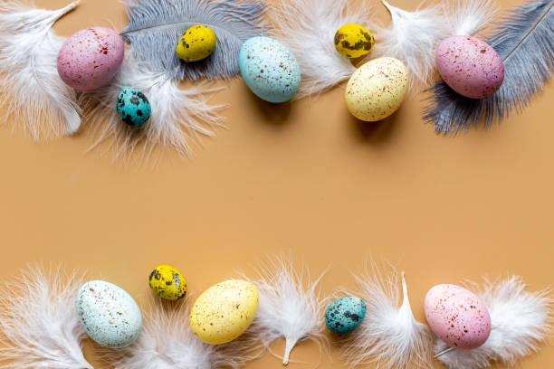 istock Happy Easter card with colorful eggs and feather. Overhead view 1309756329