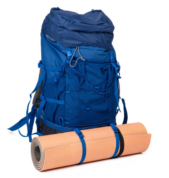 istock Blue hiking backpack with fitness mat isolated on white 1309757394