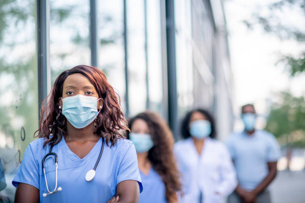 istock African female nurse wearing a protective face mask 1309759290