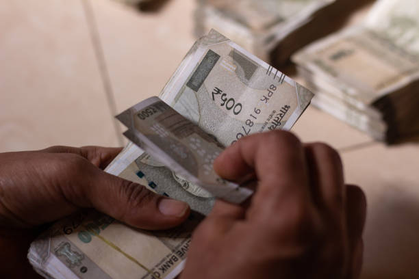 istock Person counting indian currency 500 rupees notes 1309760480
