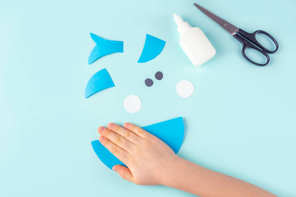 istock DIY and kids creativity. Step by step instruction: how to make shark from paper. Step4 Bend paper circle. Children Craft workshop 1309761814