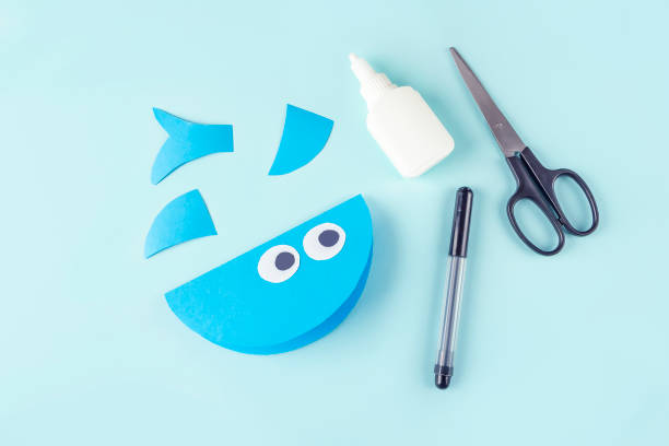 DIY and kids creativity. Step by step instruction: how to make shark from paper. Step5 glue eyes. Children Craft workshop.