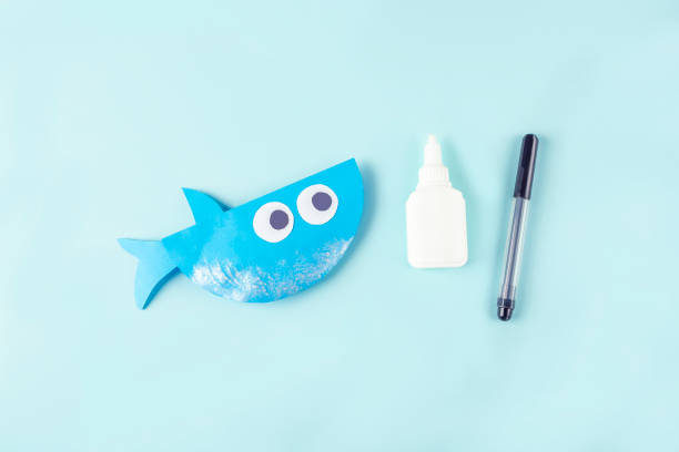 istock DIY and kids creativity. Step by step instruction: how to make shark from paper. Step7 Paint shark with silver paint. Children Craft workshop 1309761824