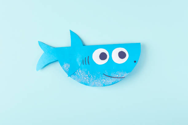 istock DIY and kids creativity. Step by step instruction: how to make shark from paper. Step10 finished shark craft. Children Craft workshop 1309761833