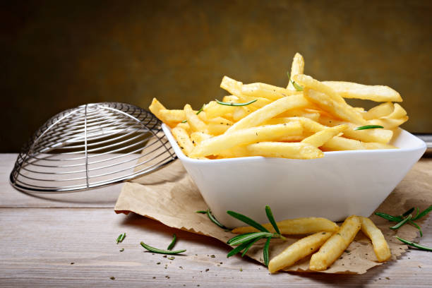 istock French fries, Chips and fresh rosemary, copy space. 1309763507