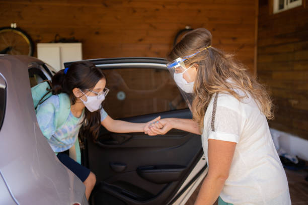 istock Mother and daughter getting ready for school with protective face mask during Covid-19. New normal. 1309766091