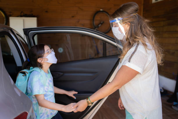 istock Mother and daughter getting ready for school with protective face mask during Covid-19. New normal. 1309766867