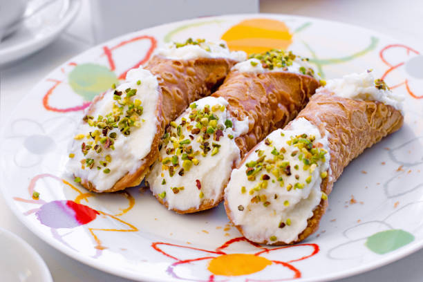 Cannoli filled with whipped cream, delicious dessert on plate Cannoli filled with whipped cream, delicious dessert on plate cannoli photos stock pictures, royalty-free photos & images