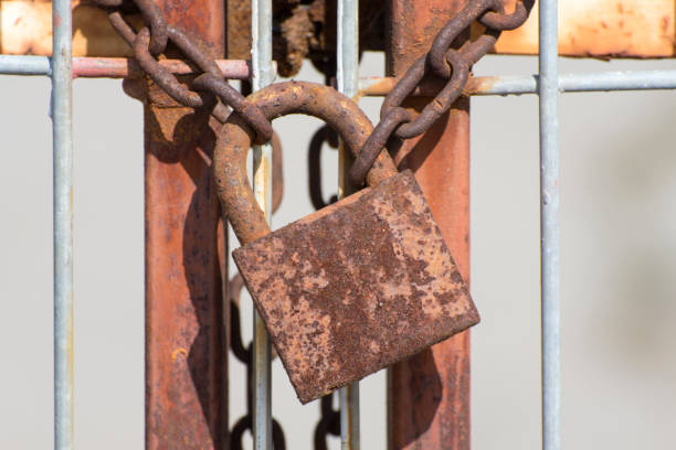 istock Rusty lock and chain on the gate. The entrance and passage are closed. 1309772182