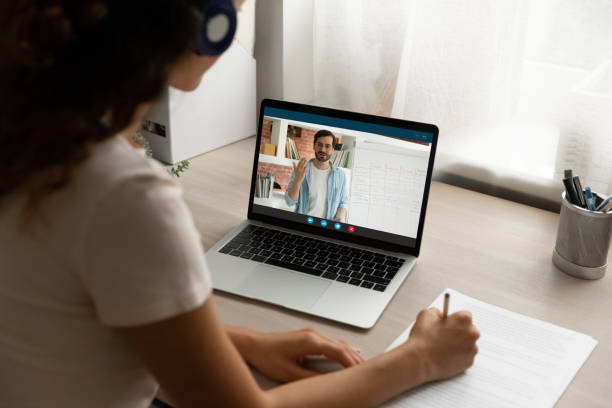 istock Focused young woman learning foreign language distantly at home. 1309772494